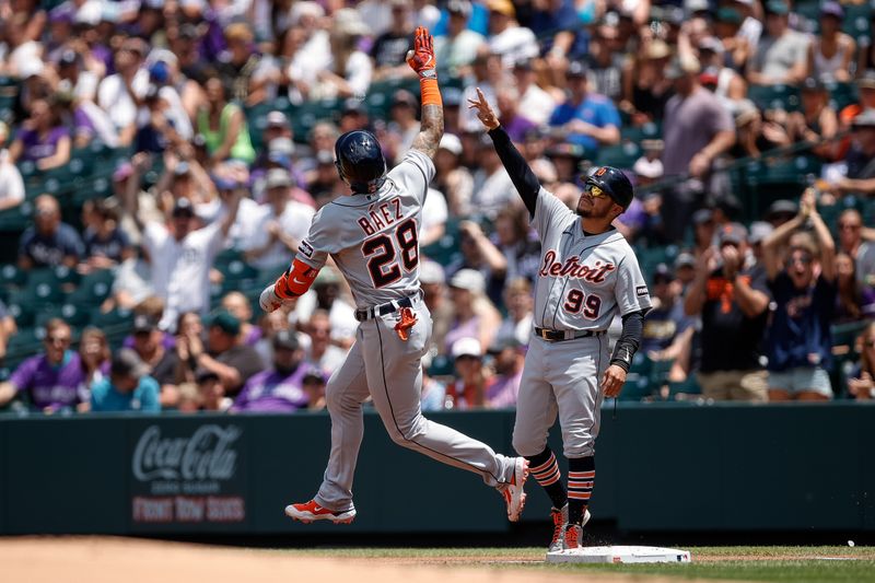 Jul 2, 2023; Denver, Colorado, USA; Detroit Tigers shortstop Javier Baez (28) celebrates with first base coach Alfredo Amezaga (99) as he rounds the bases on a grand slam in the first inning against the Colorado Rockies at Coors Field. Mandatory Credit: Isaiah J. Downing-USA TODAY Sports