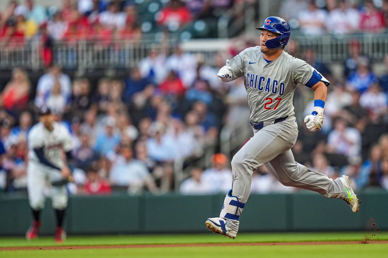 May 15, 2024; Cumberland, Georgia, USA; Chicago Cubs right fielder Seiya Suzuki (27) runs and slides after hitting a double against the Atlanta Braves during the first inning at Truist Park. Mandatory Credit: Dale Zanine-USA TODAY Sports