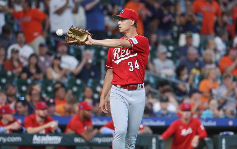 Jun 18, 2023; Houston, Texas, USA; Cincinnati Reds starting pitcher Luke Weaver (34) reacts after a play during the first inning against the Houston Astros at Minute Maid Park. Mandatory Credit: Troy Taormina-USA TODAY Sports