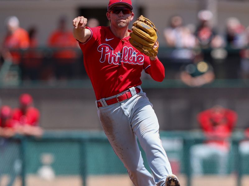 Mar 26, 2023; Sarasota, Florida, USA;  Philadelphia Phillies shortstop Scott Kingery (4) fields the ball fro an out against the Baltimore Orioles in the third inning during spring training at Ed Smith Stadium. Mandatory Credit: Nathan Ray Seebeck-USA TODAY Sports