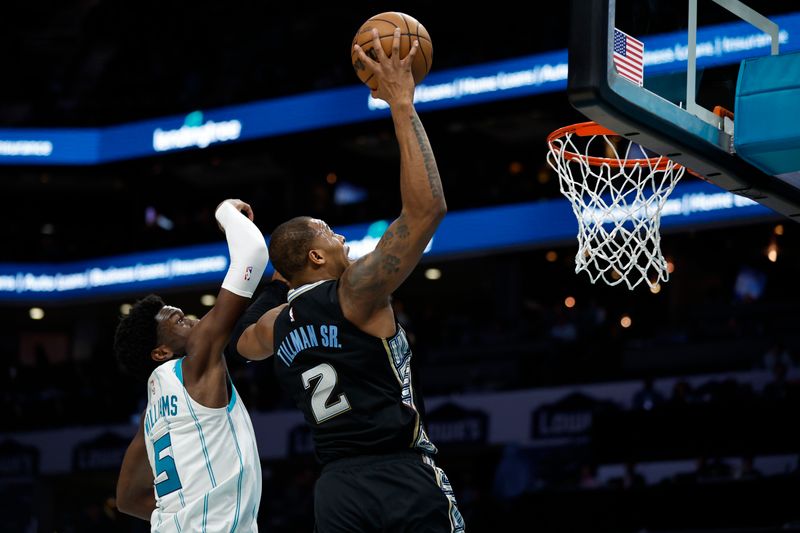 CHARLOTTE, NORTH CAROLINA - JANUARY 04: Xavier Tillman #2 of the Memphis Grizzlies dunks against Mark Williams #5 of the Charlotte Hornets during the second half of the game at Spectrum Center on January 04, 2023 in Charlotte, North Carolina. NOTE TO USER: User expressly acknowledges and agrees that, by downloading and or using this photograph, User is consenting to the terms and conditions of the Getty Images License Agreement. (Photo by Jared C. Tilton/Getty Images)