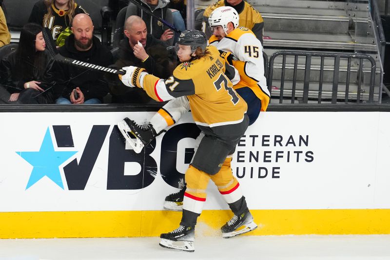 Feb 20, 2024; Las Vegas, Nevada, USA; Vegas Golden Knights center William Karlsson (71) checks Nashville Predators defenseman Alexandre Carrier (45) during the third period at T-Mobile Arena. Mandatory Credit: Stephen R. Sylvanie-USA TODAY Sports