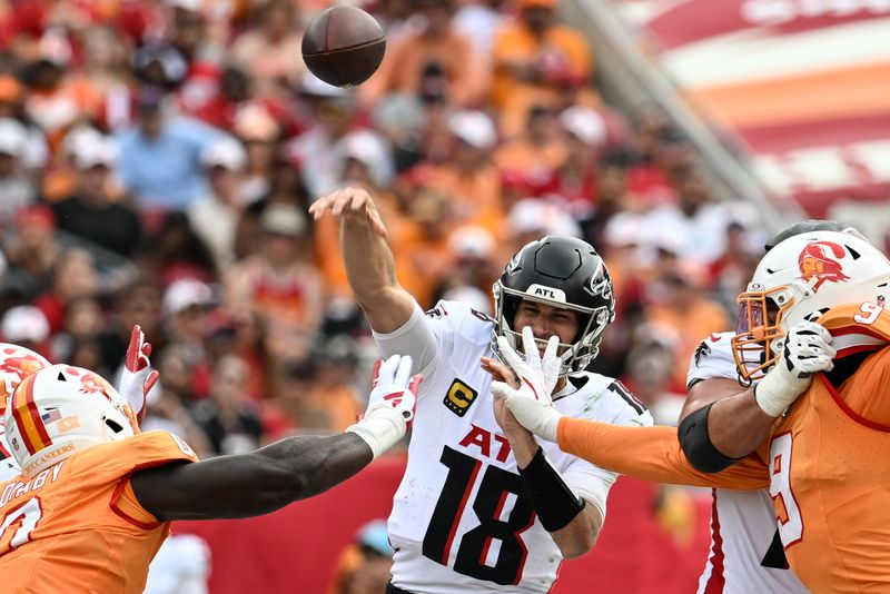 Atlanta Falcons quarterback Kirk Cousins (18) works under pressure against the Tampa Bay Buccaneers during the first half of an NFL football game, Sunday, Oct. 27, 2024, in Tampa. (AP Photo/Jason Behnken)