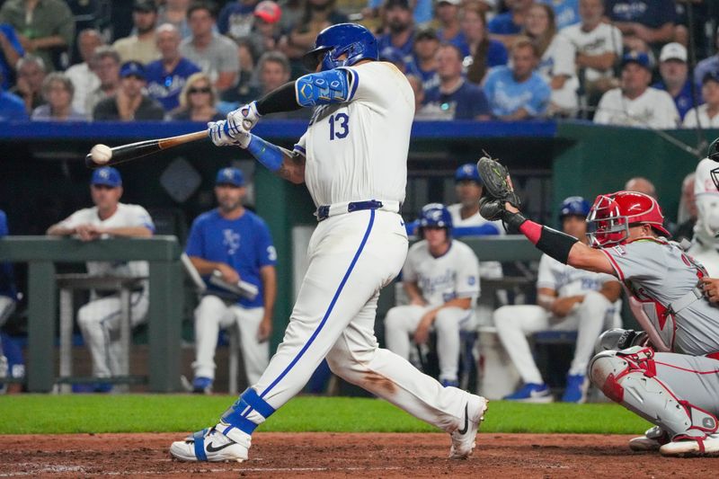 Aug 19, 2024; Kansas City, Missouri, USA; Kansas City Royals catcher Salvador Perez (13) hits a two-run double against the Los Angeles Angels in the seventh inning at Kauffman Stadium. Mandatory Credit: Denny Medley-USA TODAY Sports