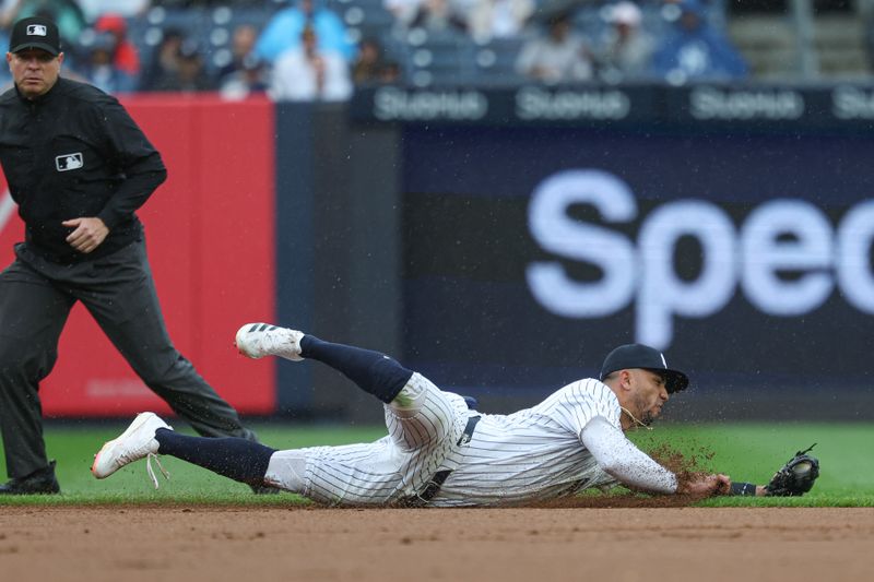 May 4, 2025; Bronx, New York, USA; New York Yankees third baseman Oswald Peraza (18) fields an infield single by Tampa Bay Rays first baseman Yandy Diaz (not pictured) during the fourth inning at Yankee Stadium. Mandatory Credit: Vincent Carchietta-Imagn Images