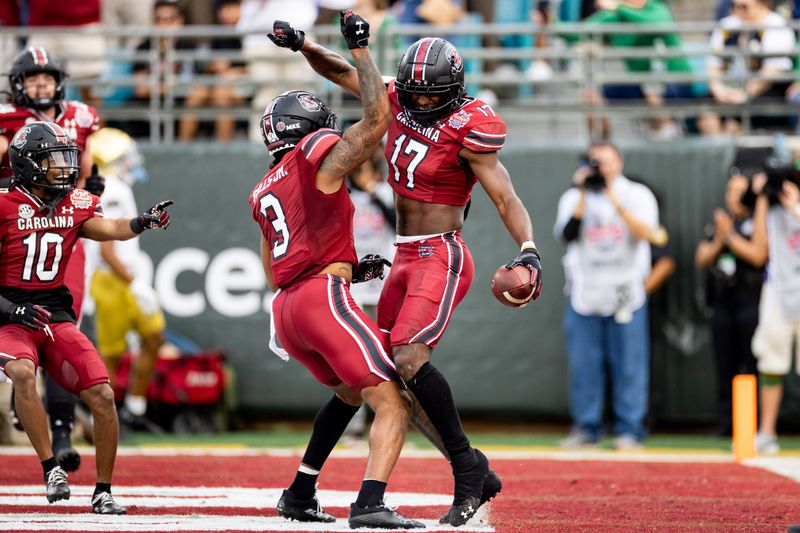 Dec 30, 2022; Jacksonville, FL, USA; South Carolina Gamecocks wide receiver Antwane Wells Jr. (3) and wide receiver Xavier Legette (17) celebrate after a touchdown during the first half against the Notre Dame Fighting Irish in the 2022 Gator Bowl at TIAA Bank Field. Mandatory Credit: Matt Pendleton-USA TODAY Sports