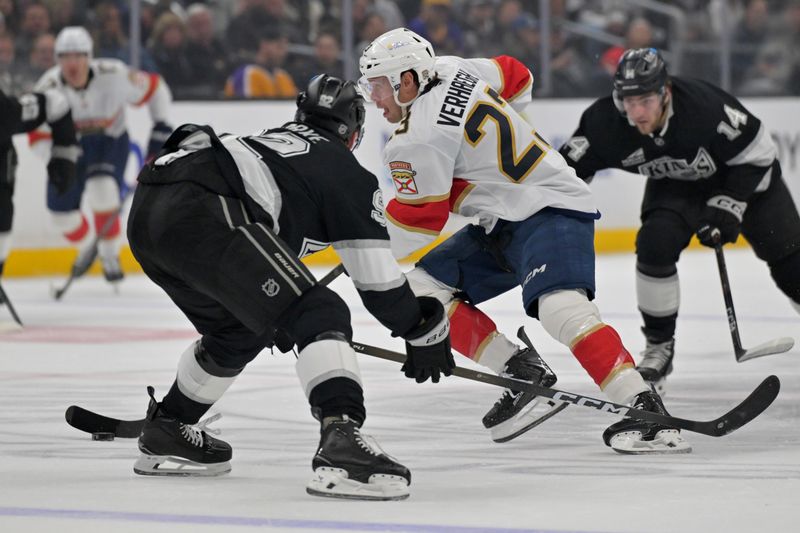 Nov 6, 2025; Los Angeles, California, USA;  Florida Panthers center Carter Verhaeghe (23) skates the puck past Los Angeles Kings defenseman Brandt Clarke (92) in the first period at Crypto.com Arena. Mandatory Credit: Jayne Kamin-Oncea-Imagn Images