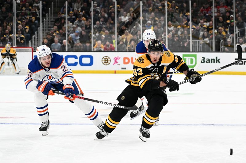 Mar 9, 2023; Boston, Massachusetts, USA; Boston Bruins left wing Brad Marchand (63) skates for the puck against Edmonton Oilers center Mattias Janmark (26) during the first period at the TD Garden. Mandatory Credit: Brian Fluharty-USA TODAY Sports