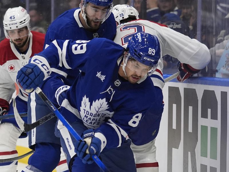 Sep 27, 2025; Toronto, Ontario, CAN; Toronto Maple Leafs forward Nicholas Robertson (89) gets possession of the puck against the Montreal Canadiens during the third period at Scotiabank Arena. Mandatory Credit: John E. Sokolowski-Imagn Images