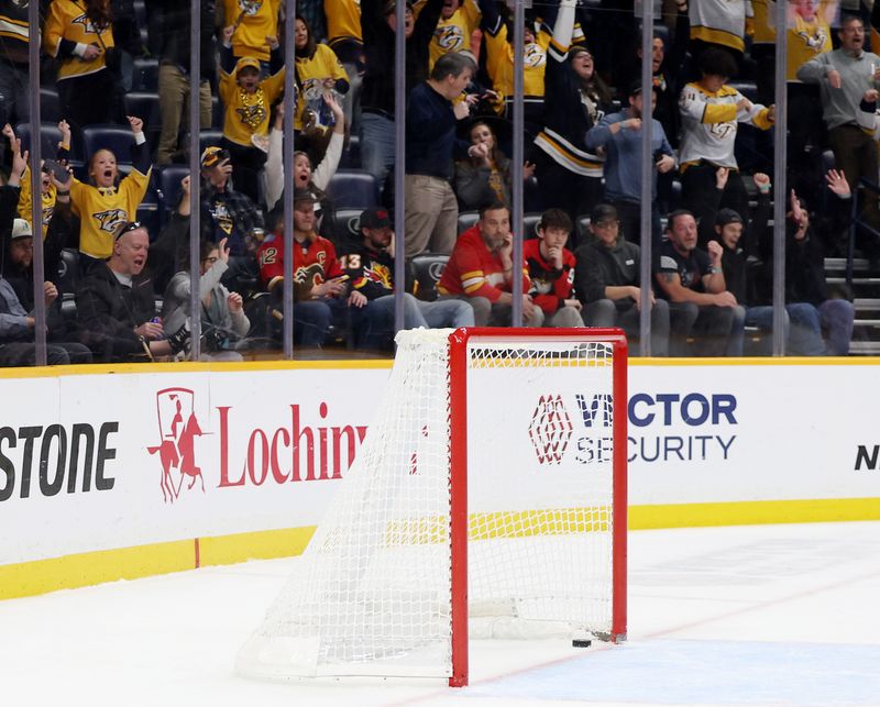 Nov 1, 2025; Nashville, Tennessee, USA; The Nashville Predators score into the open net against the Calgary Flames during the third period at Bridgestone Arena. Mandatory Credit: Alan Poizner-Imagn Images