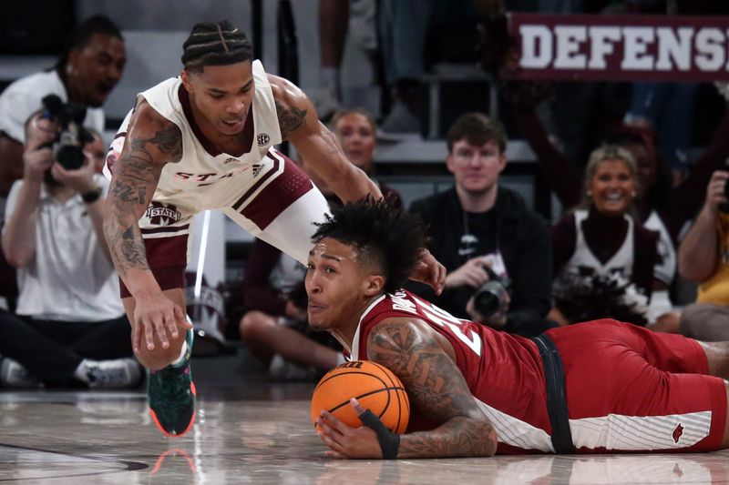 Feb 17, 2024; Starkville, Mississippi, USA; Mississippi State Bulldogs guard Shakeel Moore (3) and Arkansas Razorbacks guard Jeremiah Davenport (24) battle for a loose ball during the first half at Humphrey Coliseum. Mandatory Credit: Petre Thomagainst-USA TODAY Sports