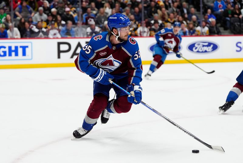 Mar 4, 2025; Denver, Colorado, USA; Colorado Avalanche defenseman Ryan Lindgren (55) controls the puck in the first period against the Pittsburgh Penguins at Ball Arena. Mandatory Credit: Ron Chenoy-Imagn Images