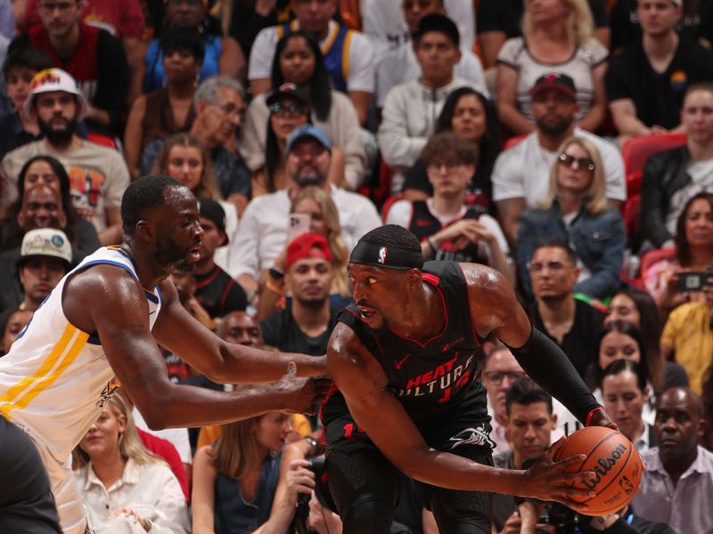 MIAMI, FL - MARCH 26:  Bam Adebayo #13 of the Miami Heat handles the ball during the game against the Golden State Warriors on March 26, 2024 at Kaseya Center in Miami, Florida. NOTE TO USER: User expressly acknowledges and agrees that, by downloading and or using this Photograph, user is consenting to the terms and conditions of the Getty Images License Agreement. Mandatory Copyright Notice: Copyright 2024 NBAE (Photo by Issac Baldizon/NBAE via Getty Images)