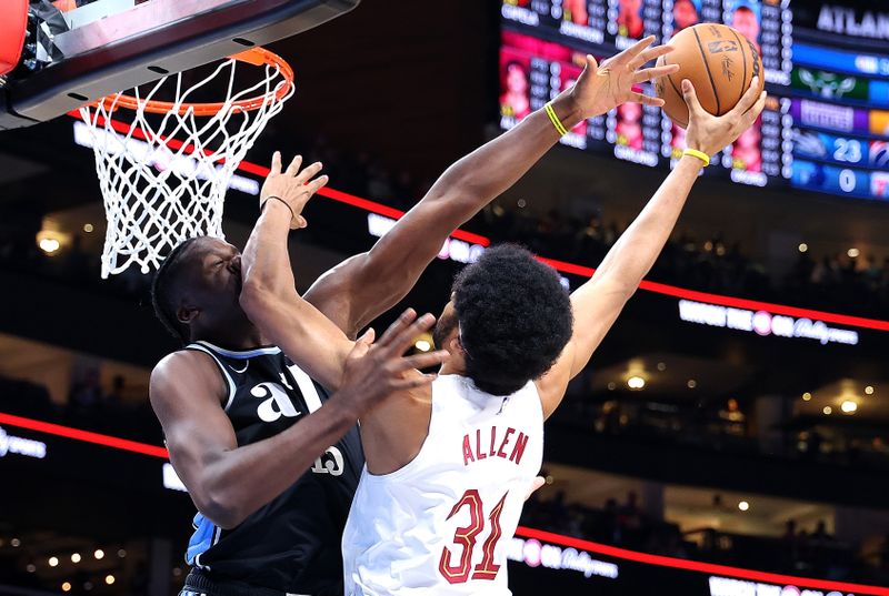 ATLANTA, GEORGIA - MARCH 06:  Jarrett Allen #31 of the Cleveland Cavaliers drives against Clint Capela #15 of the Atlanta Hawks during the first quarter at State Farm Arena on March 06, 2024 in Atlanta, Georgia.  NOTE TO USER: User expressly acknowledges and agrees that, by downloading and/or using this photograph, user is consenting to the terms and conditions of the Getty Images License Agreement.  (Photo by Kevin C. Cox/Getty Images)