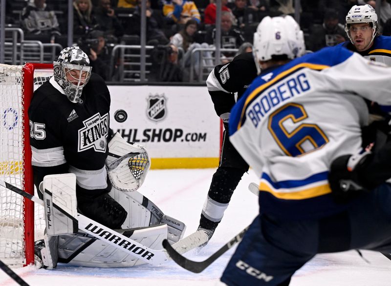 Mar 5, 2025; Los Angeles, California, USA;  Los Angeles Kings goaltender Darcy Kuemper (35) deflects a shot by St. Louis Blues defenseman Philip Broberg (6) during the third period at Crypto.com Arena. Mandatory Credit: Alex Gallardo-Imagn Images