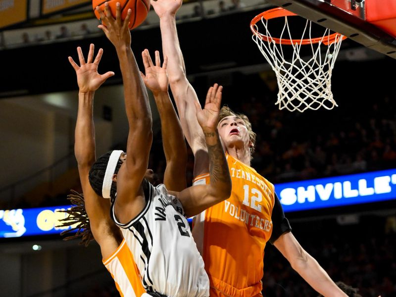 Jan 18, 2025; Nashville, Tennessee, USA;  Tennessee Volunteers forward Cade Phillips (12) blocks the shot of Vanderbilt Commodores guard MJ Collins Jr. (2) during the first half at Memorial Gymnasium. Mandatory Credit: Steve Roberts-Imagn Images