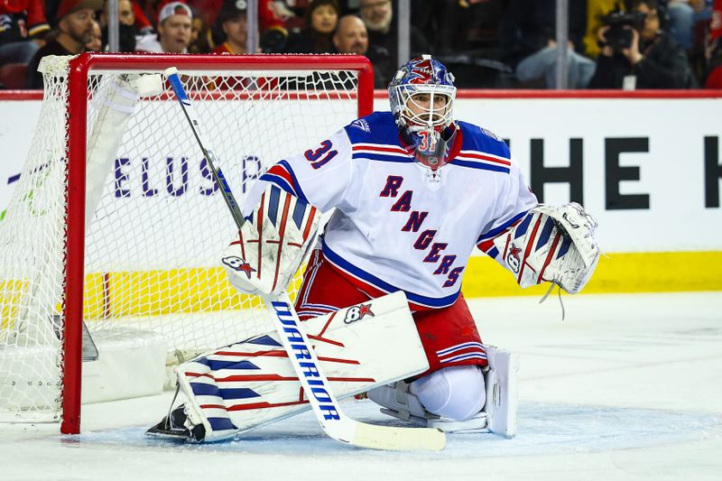 Oct 26, 2025; Calgary, Alberta, CAN; New York Rangers goaltender Igor Shesterkin (31) guards his net against the Calgary Flames during the second period at Scotiabank Saddledome. Mandatory Credit: Sergei Belski-Imagn Images