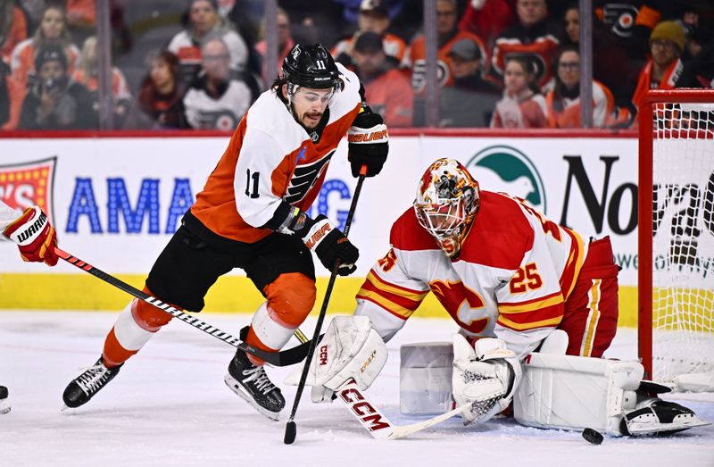 Jan 6, 2024; Philadelphia, Pennsylvania, USA; Philadelphia Flyers right wing Travis Konecny (11) dives for the puck against Calgary Flames goalie Jacob Markstrom (25) in the second period at Wells Fargo Center. Mandatory Credit: Kyle Ross-USA TODAY Sports