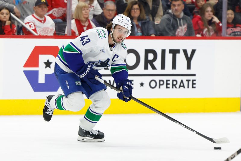 Dec 1, 2024; Detroit, Michigan, USA;  Vancouver Canucks defenseman Quinn Hughes (43) skates with the puck in the third period against the Detroit Red Wings at Little Caesars Arena. Mandatory Credit: Rick Osentoski-Imagn Images