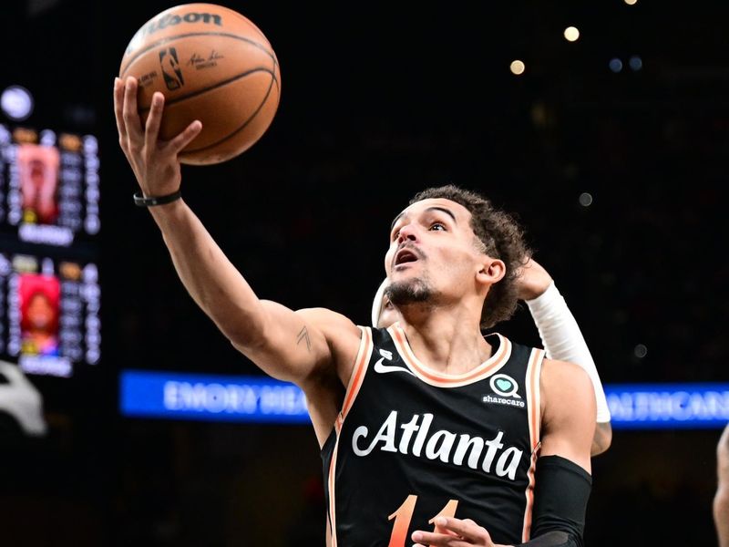 ATLANTA, GA - JANUARY 28: Trae Young #11 of the Atlanta Hawks drives to the basket during the game on January 28, 2023 at State Farm Arena in Atlanta, Georgia.  NOTE TO USER: User expressly acknowledges and agrees that, by downloading and/or using this Photograph, user is consenting to the terms and conditions of the Getty Images License Agreement. Mandatory Copyright Notice: Copyright 2023 NBAE (Photo by Adam Hagy/NBAE via Getty Images)