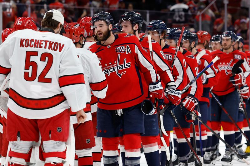 May 15, 2025; Washington, District of Columbia, USA; Washington Capitals right wing Tom Wilson (43) leads Capitals players in the handshake line with the Carolina Hurricanes after game five of the second round of the 2025 Stanley Cup Playoffs at Capital One Arena. Mandatory Credit: Geoff Burke-Imagn Images