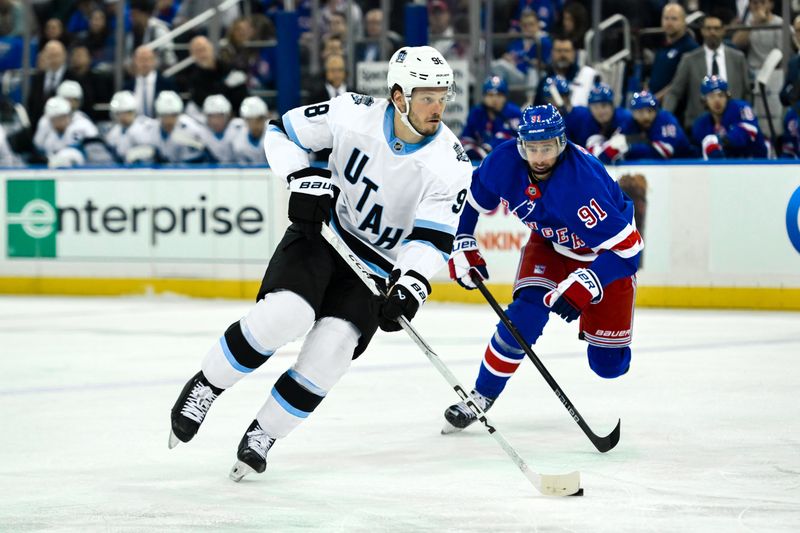 Oct 12, 2024; New York, New York, USA; Utah Hockey Club defenseman Mikhail Sergachev (98) skates past New York Rangers right wing Reilly Smith (91) during the first period at Madison Square Garden. Mandatory Credit: John Jones-Imagn Images