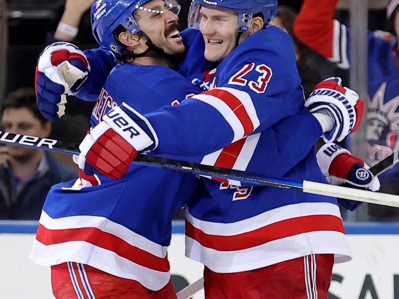 Mar 26, 2024; New York, New York, USA; New York Rangers defenseman Adam Fox (23) celebrates his game winning goal against the Philadelphia Flyers with center Vincent Trocheck (16) during overtime at Madison Square Garden. Mandatory Credit: Brad Penner-USA TODAY Sports