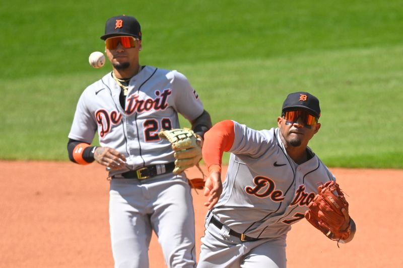 Aug 20, 2023; Cleveland, Ohio, USA; Detroit Tigers second baseman Andy Ibanez (77) turns a double play beside Detroit Tigers shortstop Javier Baez (28) in the fourth inning against the Cleveland Guardians at Progressive Field. Mandatory Credit: David Richard-USA TODAY Sports