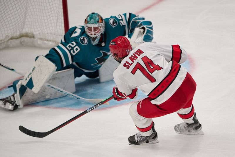 Oct 17, 2023; San Jose, California, USA; Carolina Hurricanes defenseman Jaccob Slavin (74) shoots the puck against San Jose Sharks goaltender Mackenzie Blackwood (29) during the third period at SAP Center at San Jose. Mandatory Credit: Robert Edwards-USA TODAY Sports