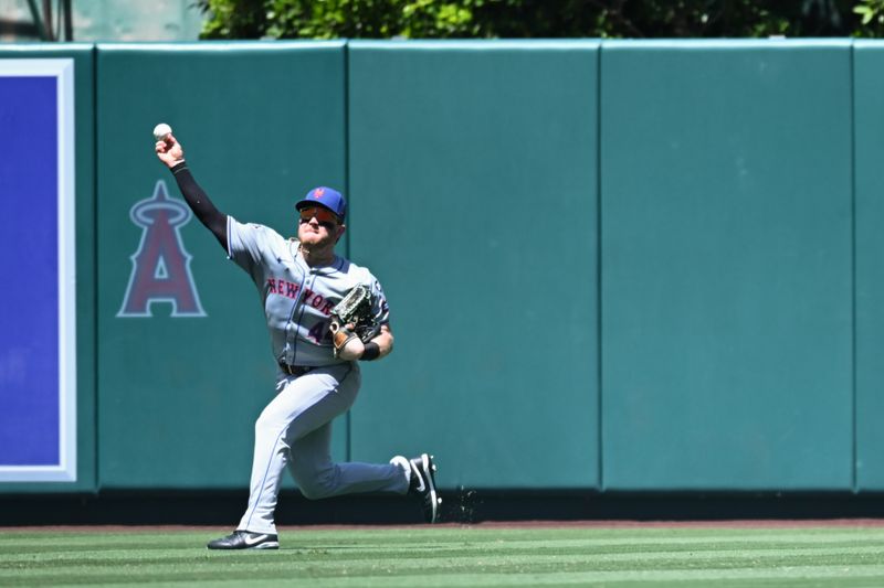 Aug 4, 2024; Anaheim, California, USA; New York Mets outfielder Harrison Bader (44) fields the ball against the Los Angeles Angels during the third inning at Angel Stadium. Mandatory Credit: Jonathan Hui-USA TODAY Sports