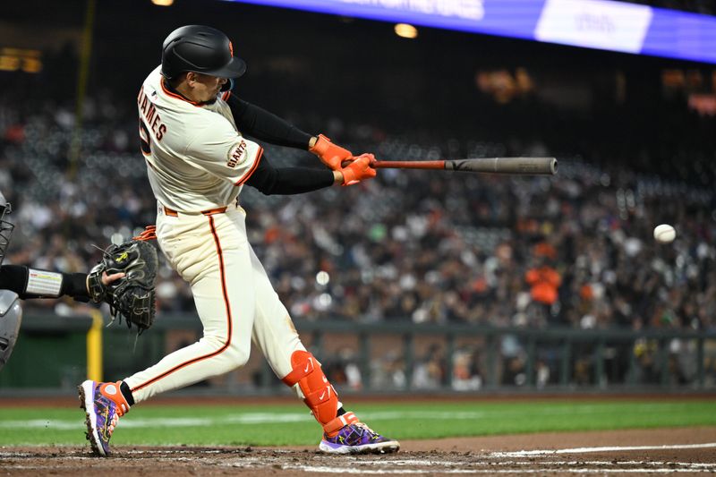 May 1, 2025; San Francisco, California, USA; San Francisco Giants shortstop Willy Adames (2) hits a single against the Colorado Rockies in the sixth inning at Oracle Park. Mandatory Credit: Eakin Howard-Imagn Images
