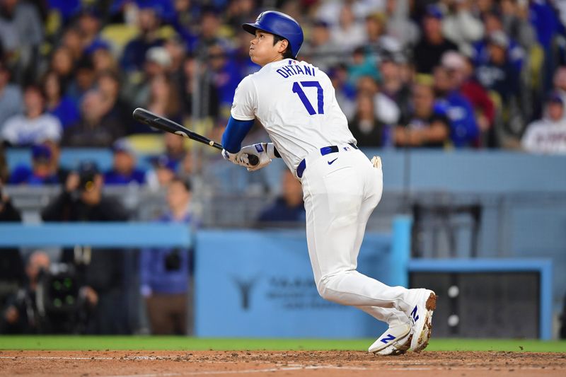 May 4, 2024; Los Angeles, California, USA; Los Angeles Dodgers designated hitter Shohei Ohtani (17) runs out a fly ball against the Atlanta Braves during the sixth inning at Dodger Stadium. Mandatory Credit: Gary A. Vasquez-USA TODAY Sports