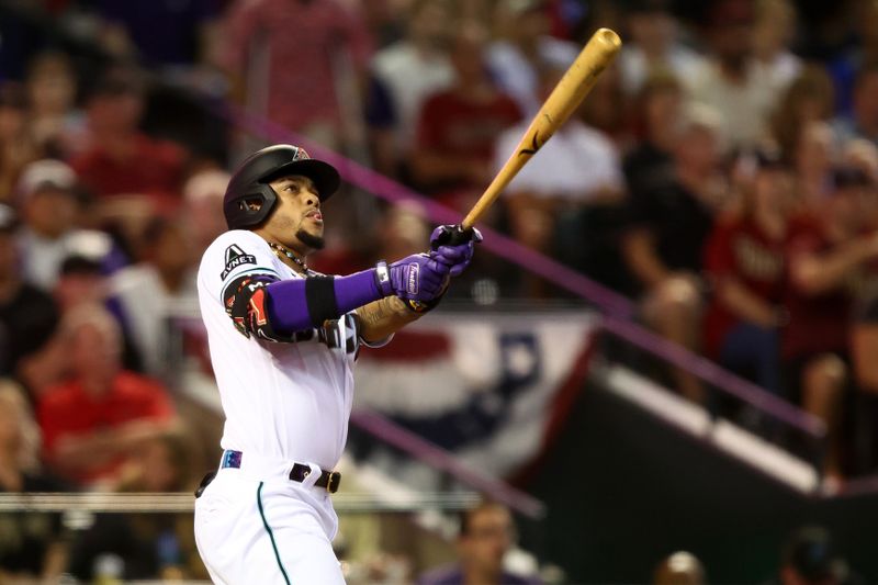 Oct 11, 2023; Phoenix, Arizona, USA; Arizona Diamondbacks second baseman Ketel Marte (4) hits a home run against the Los Angeles Dodgers in the third inning for game three of the NLDS for the 2023 MLB playoffs at Chase Field. Mandatory Credit: Mark J. Rebilas-USA TODAY Sports