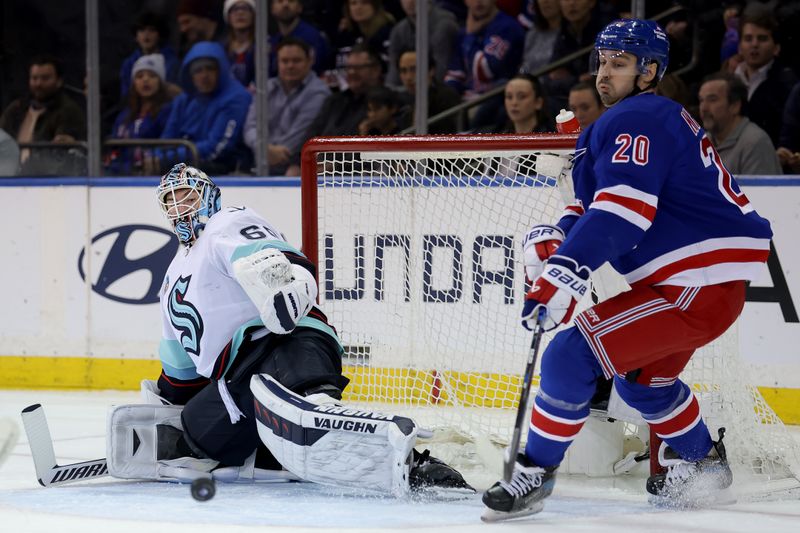 Jan 16, 2024; New York, New York, USA; Seattle Kraken goaltender Chris Driedger (60) and New York Rangers left wing Chris Kreider (20) fight for the puck during the first period at Madison Square Garden. Mandatory Credit: Brad Penner-USA TODAY Sports