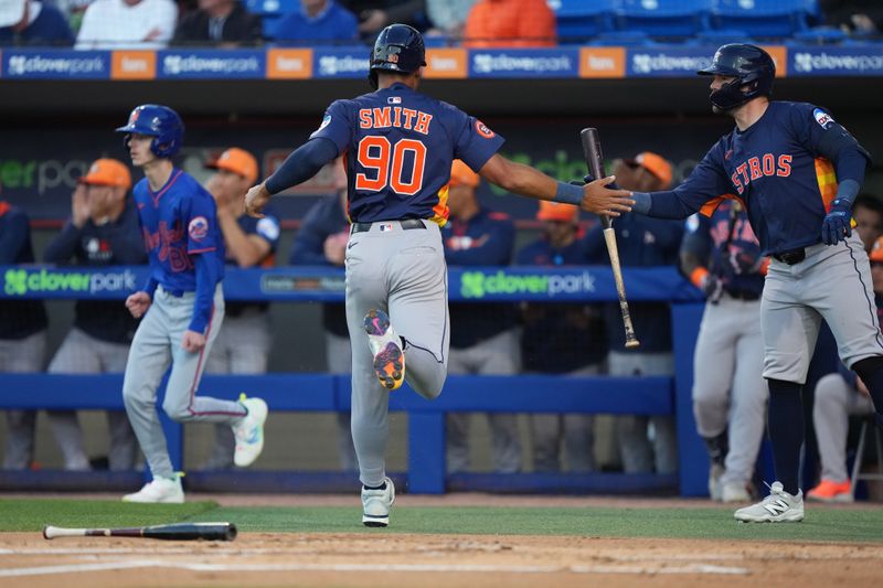 Mar 6, 2025; Port St. Lucie, Florida, USA;  Houston Astros infielder Cam Smith (90) celebrates scoring a run with teammate Chas McCormick, right, in the first inning against the New York Mets at Clover Park. Mandatory Credit: Jim Rassol-Imagn Images