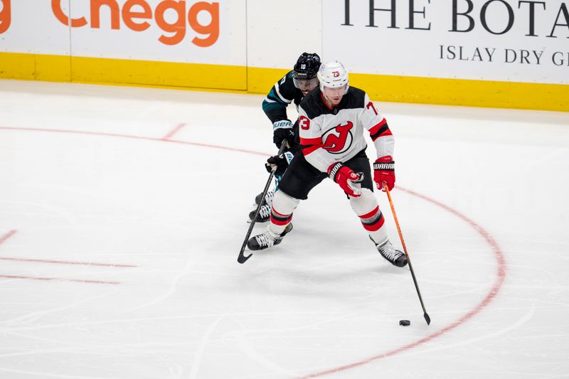 Feb 27, 2024; San Jose, California, USA;  New Jersey Devils right wing Tyler Toffoli (73) controls the puck against San Jose Sharks left wing Anthony Duclair (10) during the third period at SAP Center at San Jose. Mandatory Credit: Neville E. Guard-USA TODAY Sports