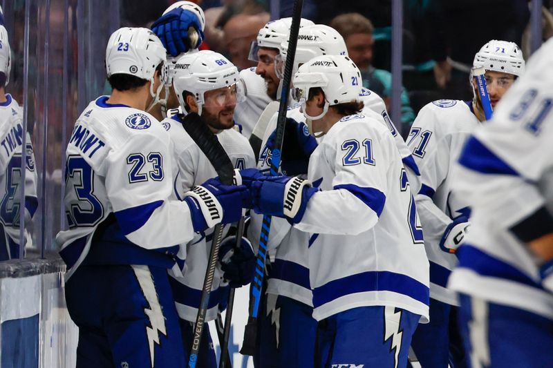 Dec 9, 2023; Seattle, Washington, USA; Tampa Bay Lightning right wing Nikita Kucherov (86, second from left), celebrates with teammates after scoring a goal against the Seattle Kraken during overtime at Climate Pledge Arena. Mandatory Credit: Joe Nicholson-USA TODAY Sports