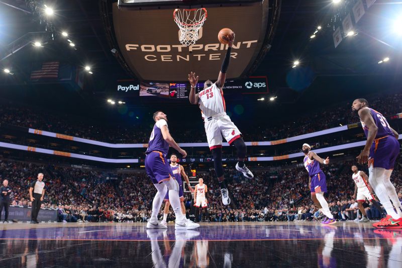 PHOENIX, AZ - NOVEMBER 6: Bam Adebayo #13 of the Miami Heat drives to the basket during the game against the Phoenix Suns on November 6, 2024 at Footprint Center in Phoenix, Arizona. NOTE TO USER: User expressly acknowledges and agrees that, by downloading and or using this photograph, user is consenting to the terms and conditions of the Getty Images License Agreement. Mandatory Copyright Notice: Copyright 2024 NBAE (Photo by Kate Frese/NBAE via Getty Images)