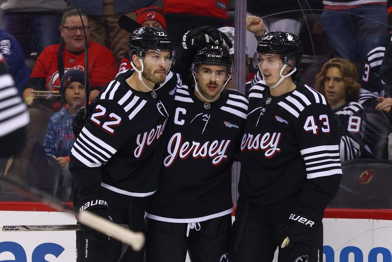 Nov 25, 2024; Newark, New Jersey, USA; New Jersey Devils center Nico Hischier (13) celebrates his goal against the Nashville Predators during the second period at Prudential Center. Mandatory Credit: Ed Mulholland-Imagn Images