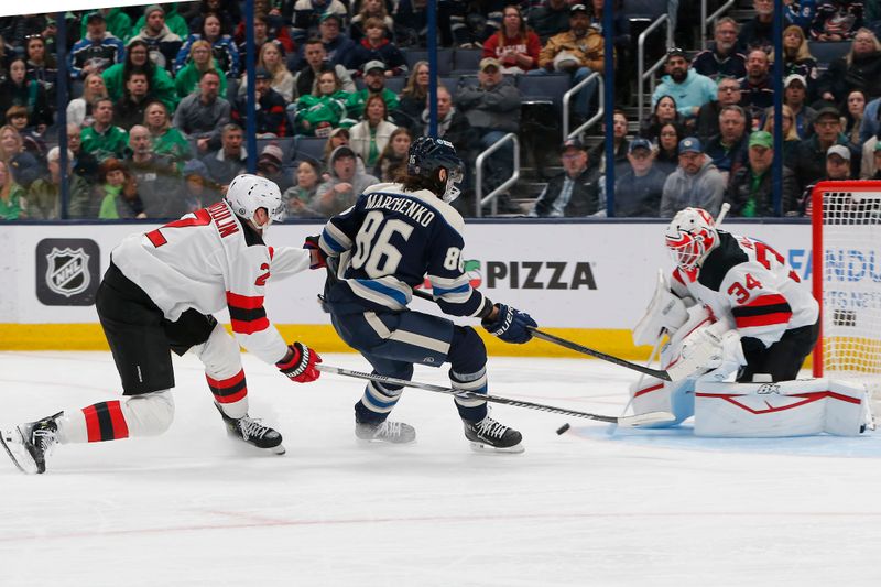 Mar 17, 2025; Columbus, Ohio, USA; Columbus Blue Jackets right wing Kirill Marchenko (86) looks for the rebound of a New Jersey Devils goalie Jake Allen (34) save during the first period at Nationwide Arena. Mandatory Credit: Russell LaBounty-Imagn Images