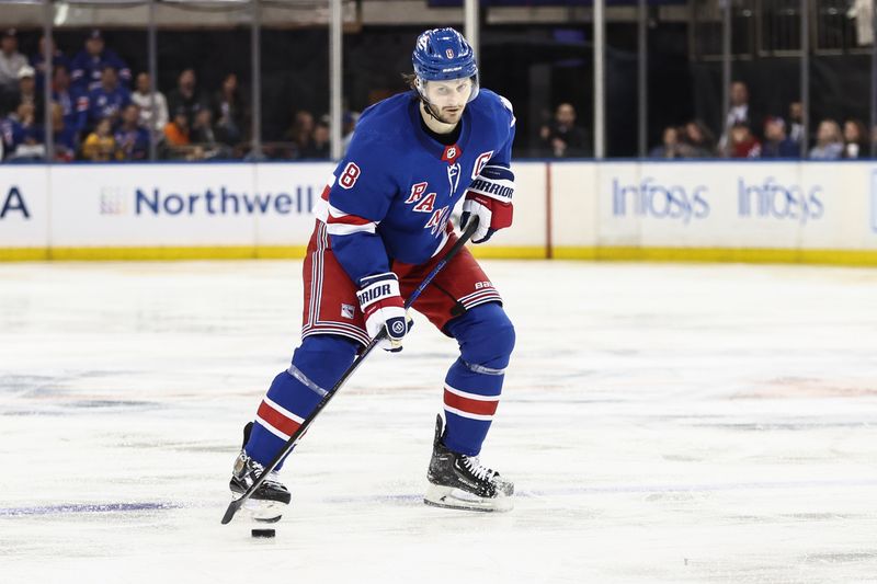 Apr 7, 2024; New York, New York, USA;  New York Rangers defenseman Jacob Trouba (8) controls the puck in the second period against the Montreal Canadiens at Madison Square Garden. Mandatory Credit: Wendell Cruz-USA TODAY Sports