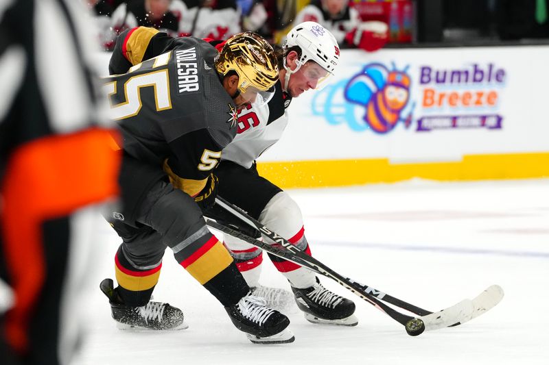 Mar 17, 2024; Las Vegas, Nevada, USA; Vegas Golden Knights right wing Keegan Kolesar (55) looks to steal the puck from New Jersey Devils left wing Erik Haula (56) during the third period at T-Mobile Arena. Mandatory Credit: Stephen R. Sylvanie-USA TODAY Sports