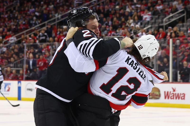 Mar 23, 2024; Newark, New Jersey, USA; New Jersey Devils defenseman Kurtis MacDermid (23) and Ottawa Senators center Mark Kastelic (12) fight during the first period at Prudential Center. Mandatory Credit: Ed Mulholland-USA TODAY Sports