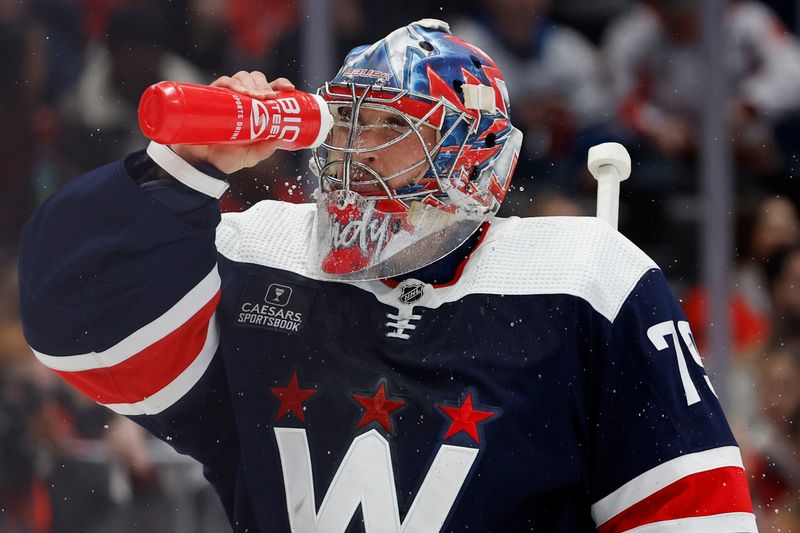 Feb 20, 2024; Washington, District of Columbia, USA; Washington Capitals goaltender Charlie Lindgren (79) squirts water on his face during a stoppage in play against the New Jersey Devils in the first period at Capital One Arena. Mandatory Credit: Geoff Burke-USA TODAY Sports