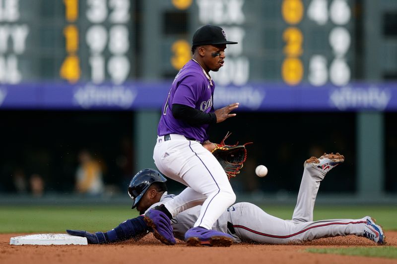 Apr 28, 2025; Denver, Colorado, USA; Atlanta Braves second baseman Ozzie Albies (1) steals second against Colorado Rockies second baseman Adael Amador (1) in the second inning at Coors Field. Mandatory Credit: Isaiah J. Downing-Imagn Images
