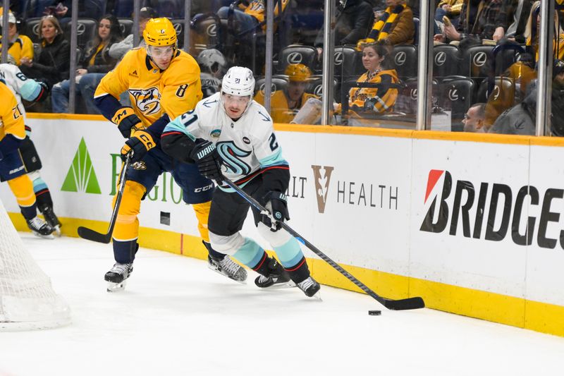 Mar 6, 2025; Nashville, Tennessee, USA;  Nashville Predators defenseman Andreas Englund (8) and Seattle Kraken center Michael Eyssimont (21) battle for the puck during the second period at Bridgestone Arena. Mandatory Credit: Steve Roberts-Imagn Images