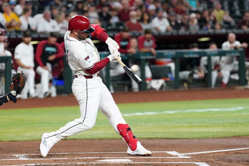 May 19, 2024; Phoenix, Arizona, USA; Arizona Diamondbacks first base Christian Walker (53) hits a sacrifice fly RBI against the Detroit Tigers during the first inning at Chase Field. Mandatory Credit: Joe Camporeale-USA TODAY Sports