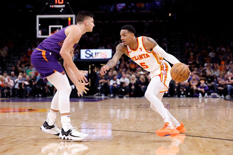 PHOENIX, ARIZONA - MARCH 21: Dejounte Murray #5 of the Atlanta Hawks drives on Grayson Allen #8 of the Phoenix Suns during the first half at Footprint Center on March 21, 2024 in Phoenix, Arizona. NOTE TO USER: User expressly acknowledges and agrees that, by downloading and or using this photograph, User is consenting to the terms and conditions of the Getty Images License Agreement.  (Photo by Chris Coduto/Getty Images)