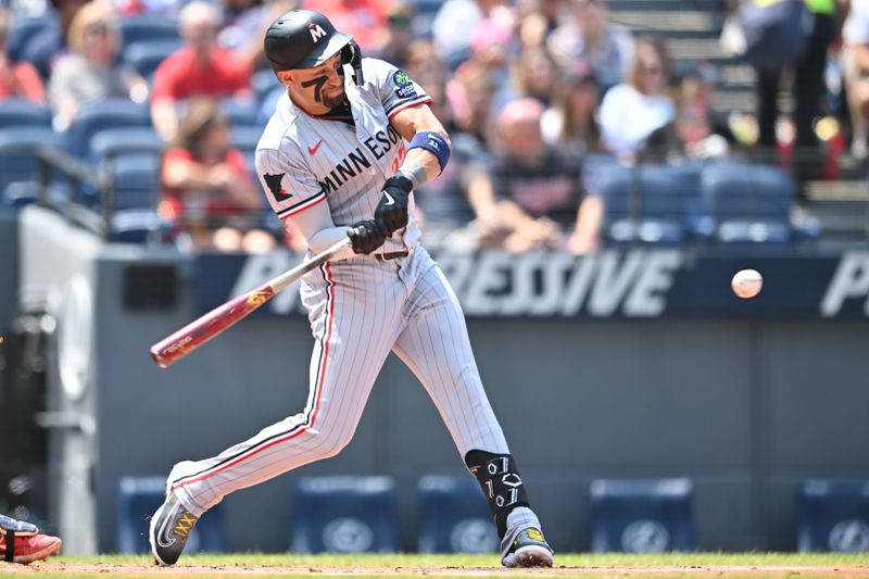 Aug 3, 2025; Cleveland, Ohio, USA; Minnesota Twins third baseman Royce Lewis (23) hits an RBI double during the first inning against the Cleveland Guardians at Progressive Field. Mandatory Credit: Ken Blaze-Imagn Images