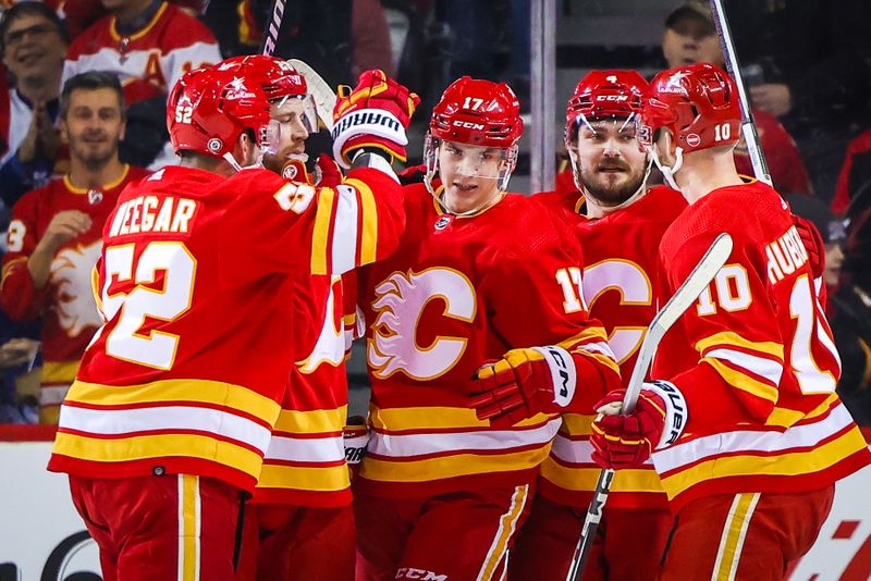 Jan 18, 2024; Calgary, Alberta, CAN; Calgary Flames center Yegor Sharangovich (17) celebrates his goal with teammates against the Toronto Maple Leafs during the first period at Scotiabank Saddledome. Mandatory Credit: Sergei Belski-USA TODAY Sports